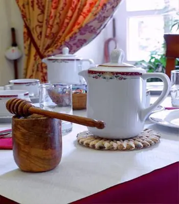 a table with a tea pot and a wooden spoon at Hostal Alfonso in Santiago de Compostela