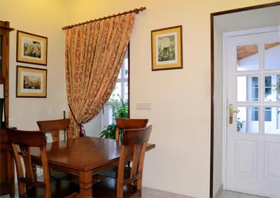 a dining room with a wooden table and chairs at Hostal Alfonso in Santiago de Compostela