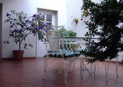 a table and chairs with flowers on a patio at Hostal Alfonso in Santiago de Compostela