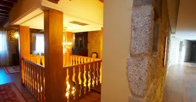 a hallway of a church with a wooden staircase at Hotel Vila do Val in O Valadouro