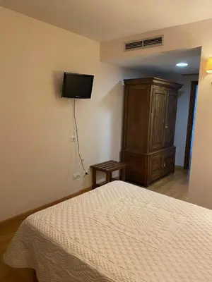 a bedroom with a large bed and two lamps at Hotel Vila do Val in O Valadouro
