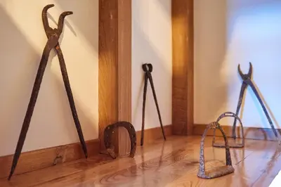 three metal items on the floor in a room at Casa Entera A Ferradura in Melide
