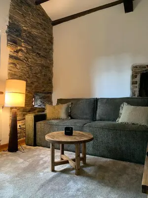 a living room with a green couch and a table at Casas do Campo in Monfero