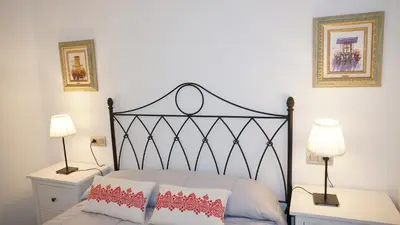 a bedroom with a bed with two night stands and two lamps at Apartamento Vía Romana XIX in Lugo