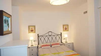 a bedroom with a bed with two tables and two lamps at Apartamento Vía Romana XIX in Lugo
