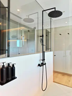 a shower in a bathroom with a white counter top at Noa Boutique Hotel in Santa Cruz de Oleiros