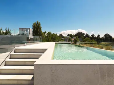 a swimming pool with stairs next to a building at Noa Boutique Hotel in Santa Cruz de Oleiros