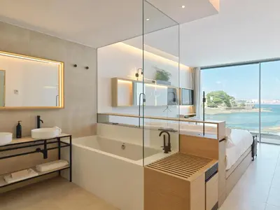 a bathroom with a shower and a tub and a sink at Noa Boutique Hotel in Santa Cruz de Oleiros