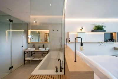 a bathroom with two sinks and a shower at Noa Boutique Hotel in Santa Cruz de Oleiros