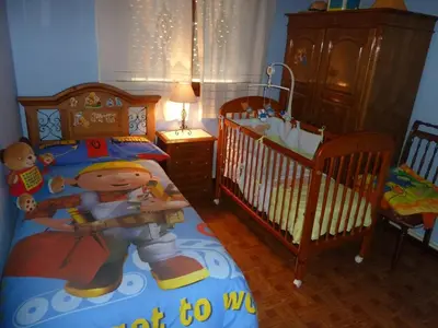 a childs bedroom with two cribs and a toddler bed at CHALT EN MIÑO CON VISTAS AL MAR in A Coruña