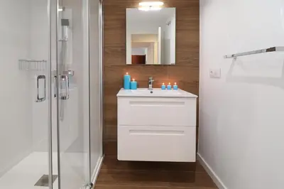 a bathroom with a white sink and a shower at Estación de tren by Como en Casa in Santiago de Compostela