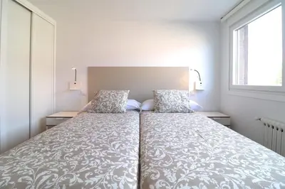 a bedroom with a large bed with two pillows at Estación de tren by Como en Casa in Santiago de Compostela