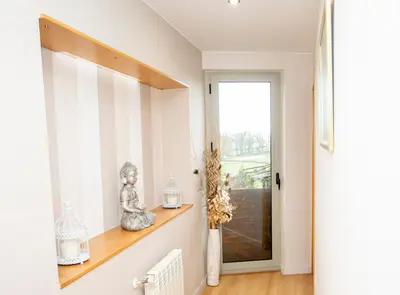 a hallway with a window and a shelf with vases at CASA CINES in Lugo
