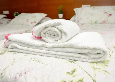 a pile of towels sitting on top of a bed at CASA CINES in Lugo