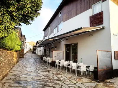 a cobblestone alley with tables and chairs outside of a building at CASA CINES in Lugo