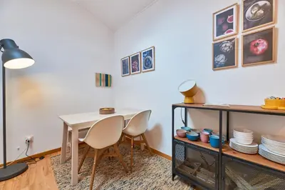 a dining room with a white table and chairs at Berce in Arzúa