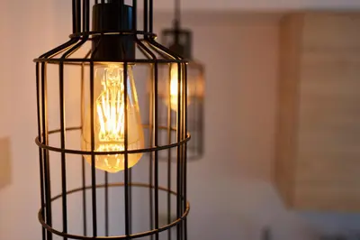 a black cage with a light inside of it at Berce in Arzúa