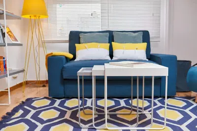 a living room with a blue couch and a table at Berce in Arzúa