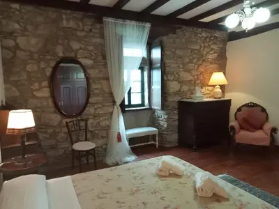 a bedroom with a bed and a stone wall at Palacio de Cantiz 