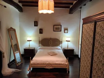a bedroom with a bed and two lamps and a mirror at Palacio de Cantiz 