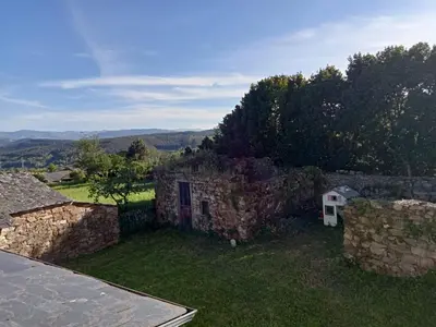 an external view of a stone building with a yard at Palacio de Cantiz 