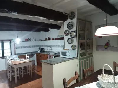 a kitchen with a counter and a table with chairs at Palacio de Cantiz 