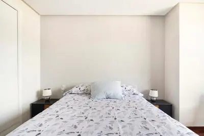 a bedroom with a bed and two night stands at Apartamento en el centro de Ourense in Ourense