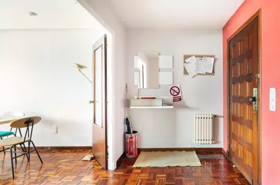 a room with a door and a table and chairs at Apartamento en el centro de Ourense in Ourense