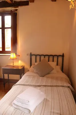a bedroom with a bed with towels on it at Casa Rural Norita - Adults only in Lourenzá