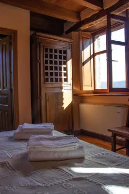 a room with two towels on a bed with windows at Casa Rural Norita - Adults only in Lourenzá