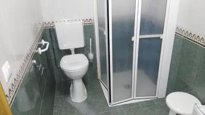 a bathroom with a toilet and a shower at Hotel Casa Benilde in Palas de Rei