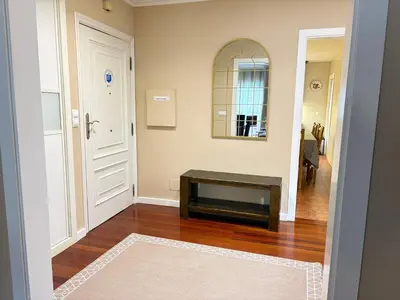 a living room with a table and a mirror at Home Sweet Home in Caldas de Reis