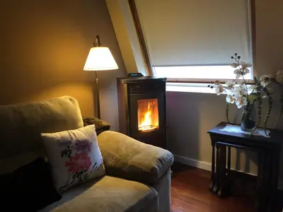 a living room with a couch and a fire place at Home Sweet Home in Caldas de Reis