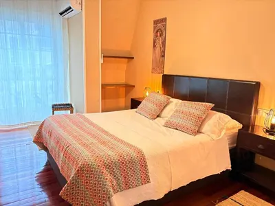 a bedroom with a bed with a blanket and pillows at Home Sweet Home in Caldas de Reis