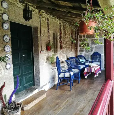 a group of blue chairs sitting on a porch at Casa do Pacio Sabadelle in Lugo