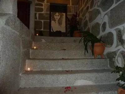a set of stairs with candles and potted plants at Casa do Pacio Sabadelle in Lugo