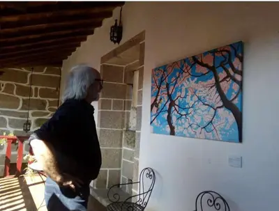a man standing next to a painting on a wall at Casa do Pacio Sabadelle in Lugo
