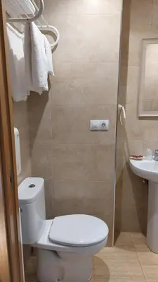 a bathroom with a toilet and a sink at Albergue la escuela in La Laguna
