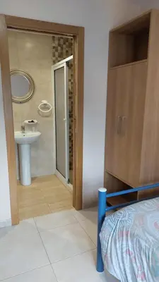 a bathroom with a sink and a bathroom with a mirror at Albergue la escuela in La Laguna
