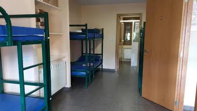 a hallway with four bunk beds in a room at Albergue la escuela in La Laguna