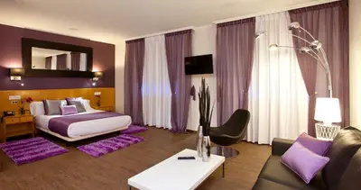 a hotel room with a bed and a couch at Hotel Palacio de Cristal in Burela de Cabo