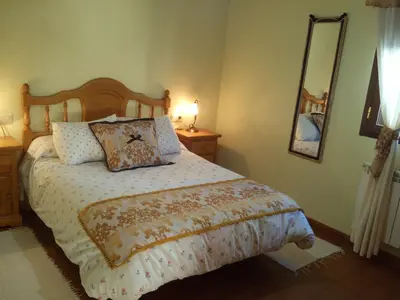 a bedroom with a bed and a mirror on the wall at Casa Rural Las Nieves in San Ciprián