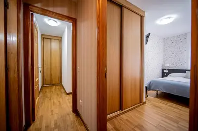 a room with a bedroom with a bed and a door at Noja rooms 2 in O Pedrouzo