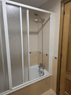 a shower with a glass door in a bathroom at Noja rooms 2 in O Pedrouzo