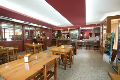 a restaurant with wooden tables and a bar at Hotel TERRANOVA in Oza dos Ríos