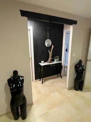 a living room with two black cats and a table at A Casa do Calexón in Viveiro