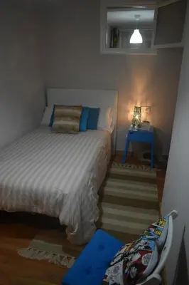 a small bedroom with a bed and a blue table at A Casa do Calexón in Viveiro