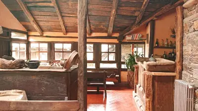 a kitchen with a wooden ceiling and a table at Casa O´Crego in San Román