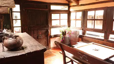 a room with a table and chairs and windows at Casa O´Crego in San Román