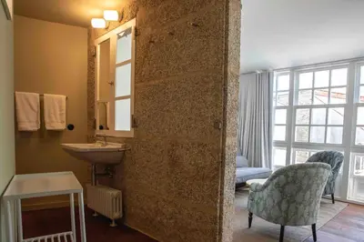 a bathroom with a sink and a mirror at Inferniño Apartments in Santiago de Compostela